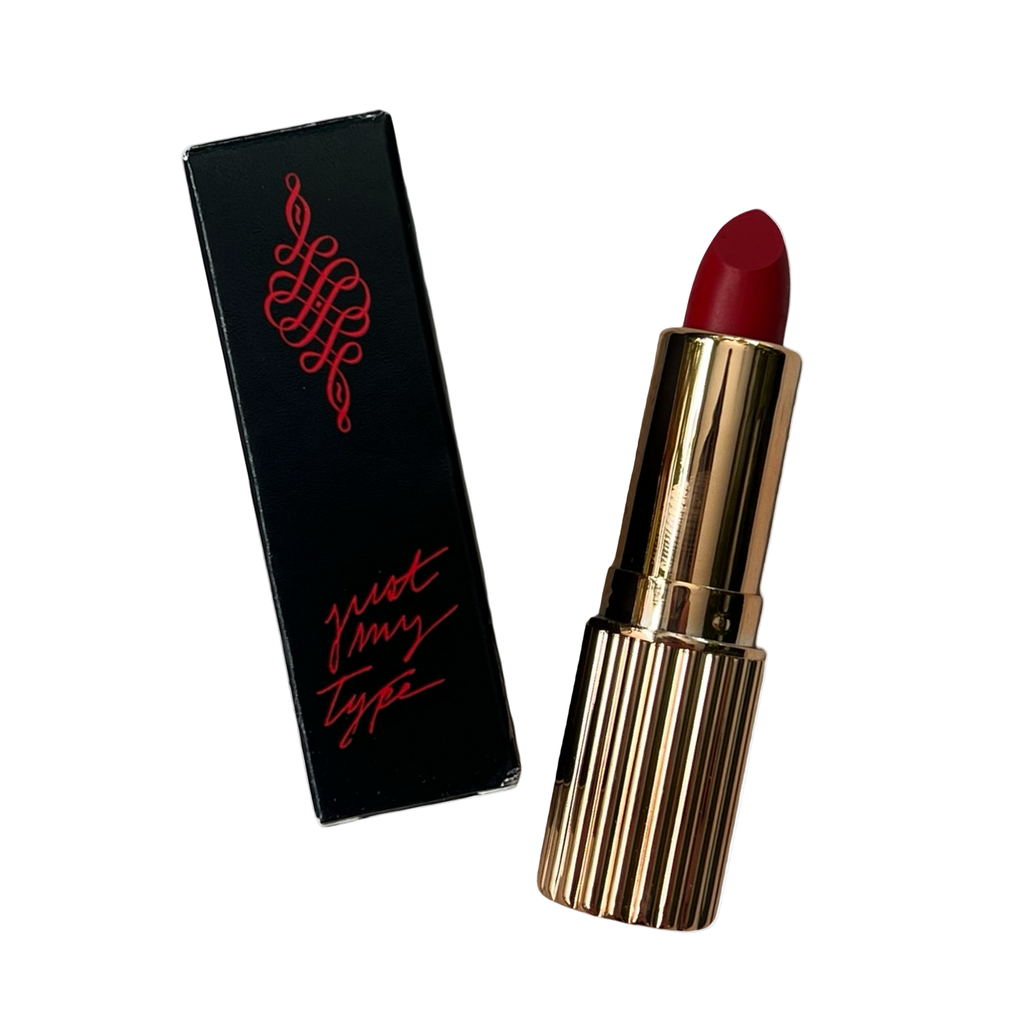 Red lipstick with gold casing and black packaging featuring red text on a white background