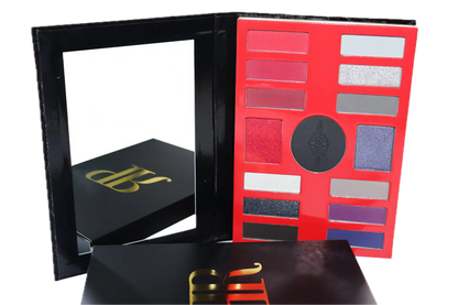 Makeup palette with color swatches and a black box with gold lettering on a white background