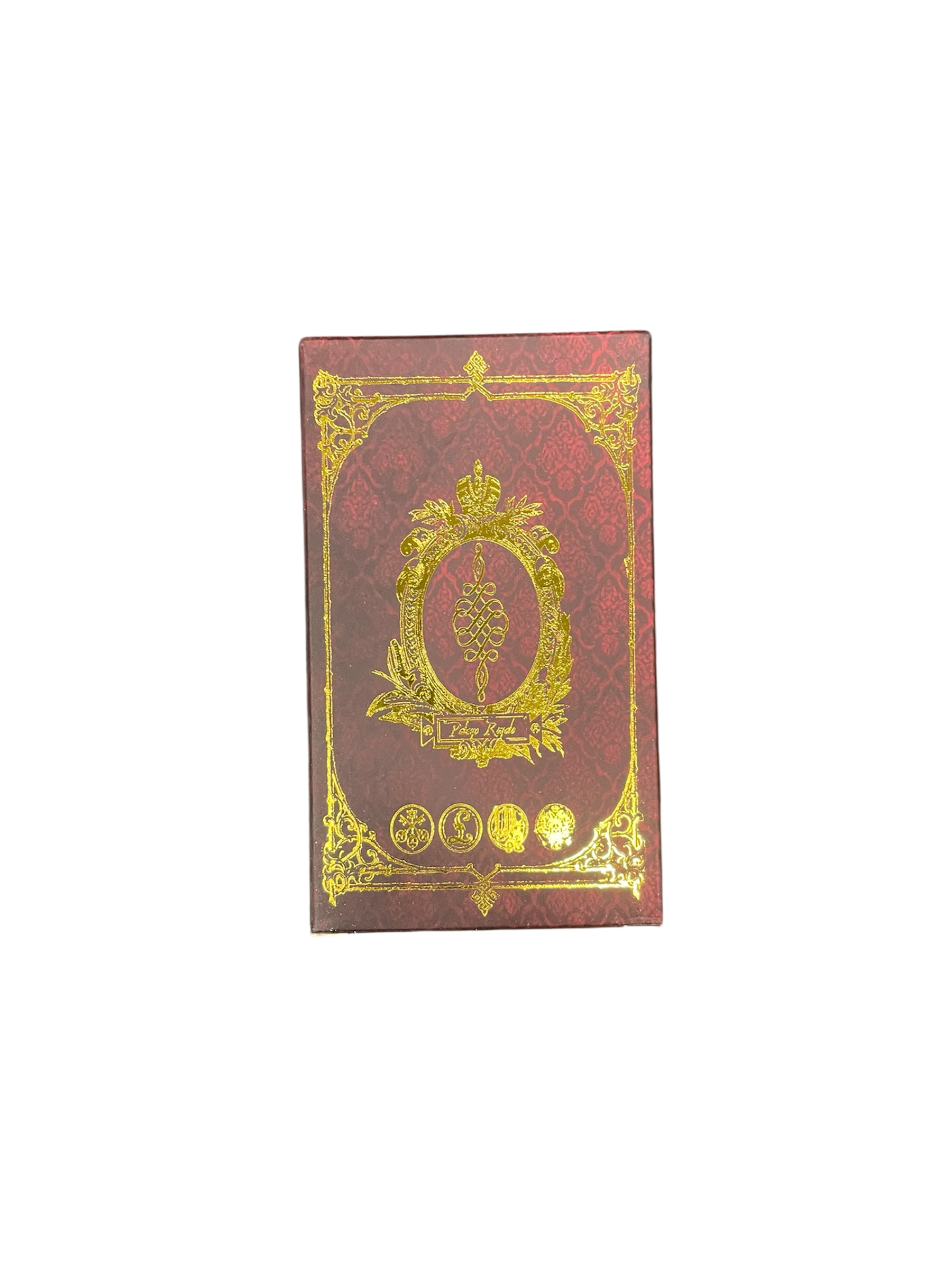 Decorative red book with gold embossed design on a white background